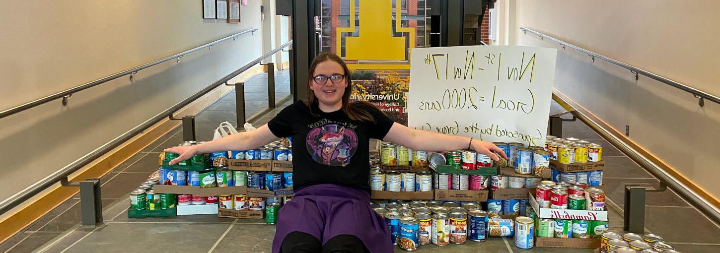 University of Idaho student, Zoe Evans stacks cans of food she purchased for a donation.